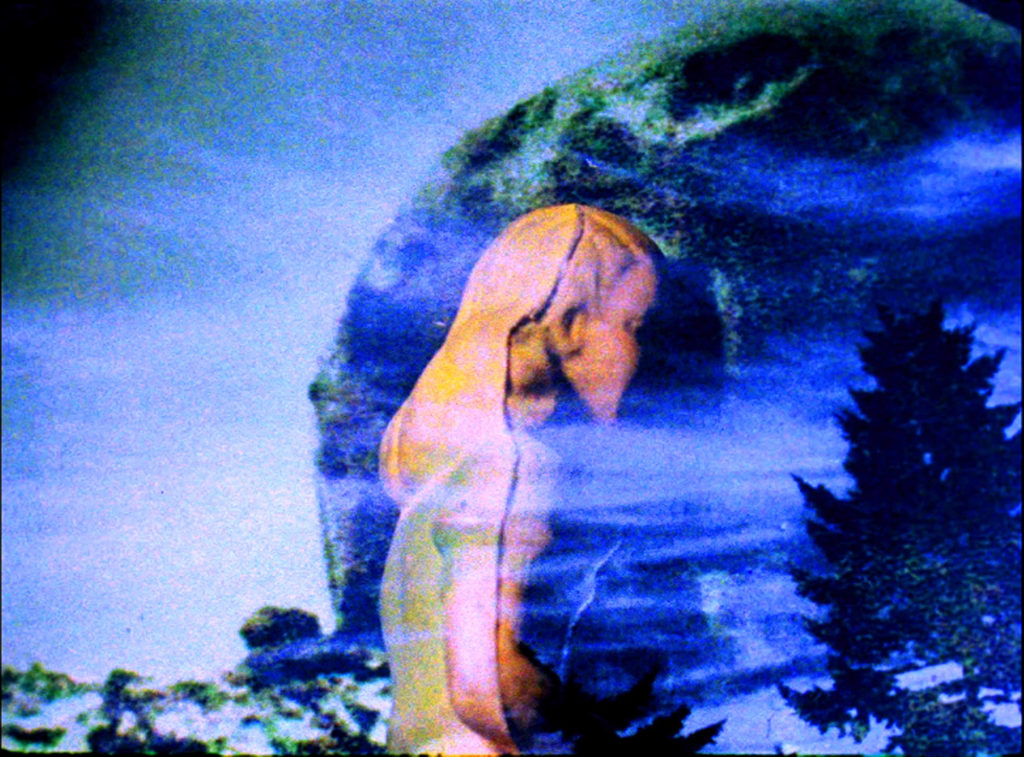 Still from a video by Janie Geiser, doll and sky