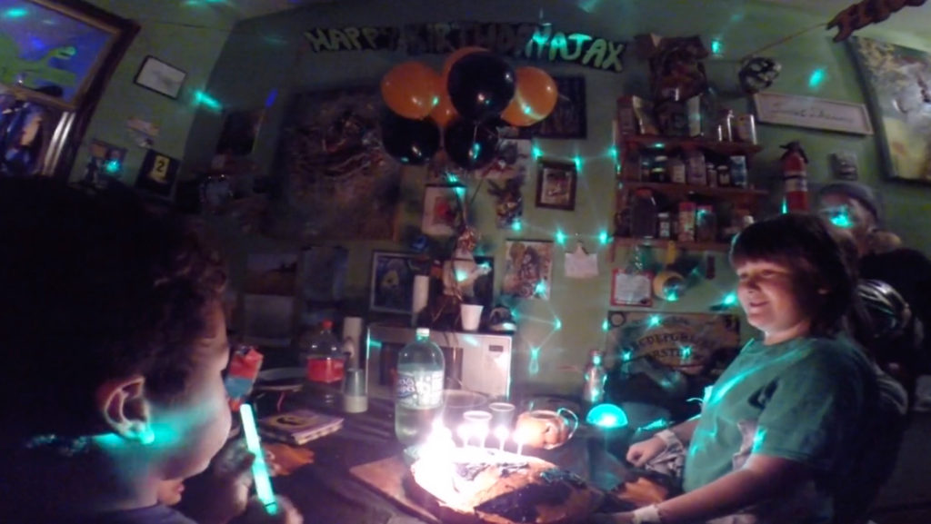 Still from a video by Marni Kotak, kitchen room with disco light