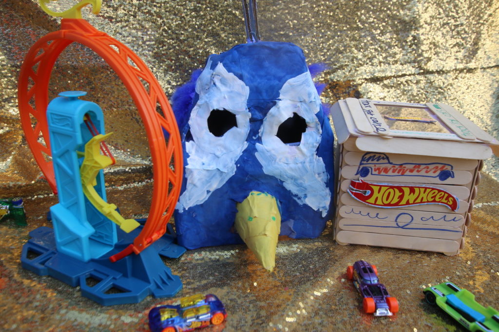 Toys and a peacock mask by Ajax Kotak Bell