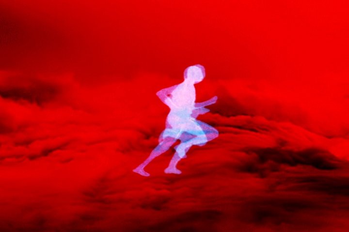 Still from a film by Leslie Supnet, runner against red background
